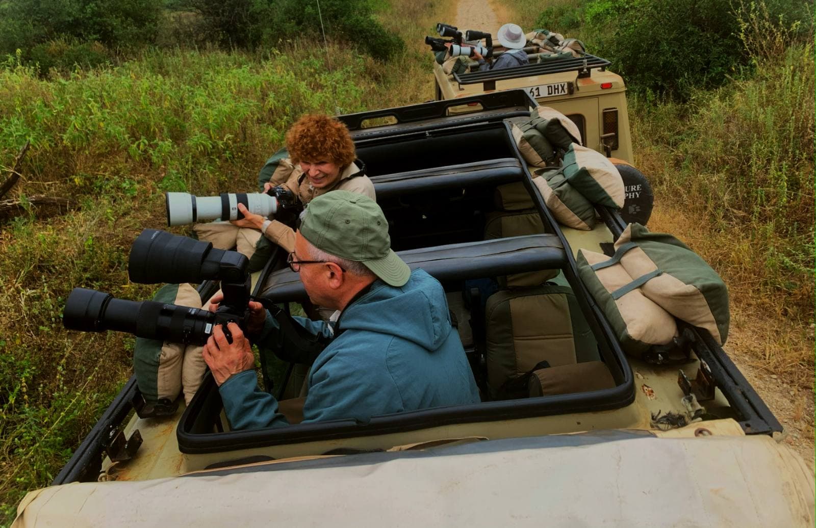 Wildlife photographer working from a safari vehicle in the field
