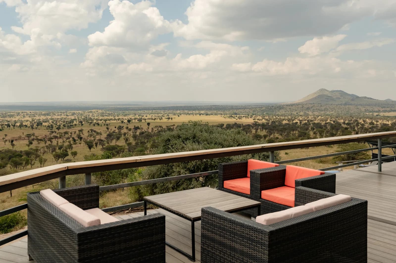 Deck chairs on a terrace looking out over the plains to a distant hill
