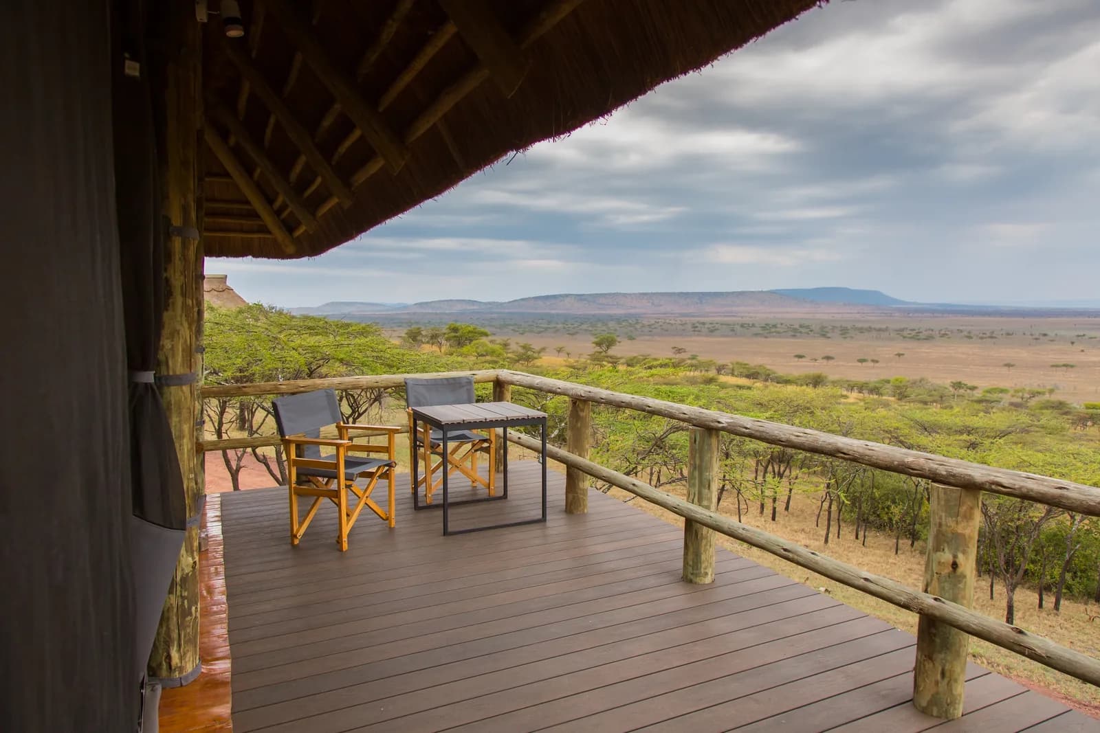 Covered deck with a table and chairs looking out over the plains