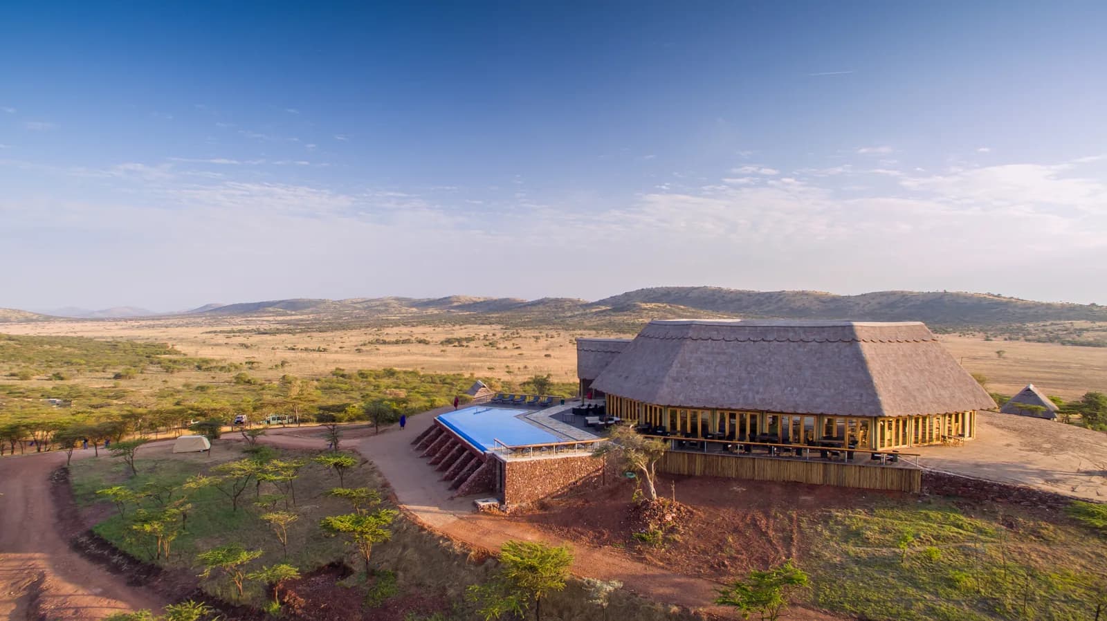 The lodge and its pool on a ridge above the plains