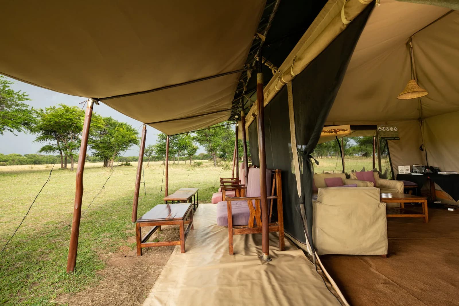 Tent veranda with armchairs, looking into the lounge