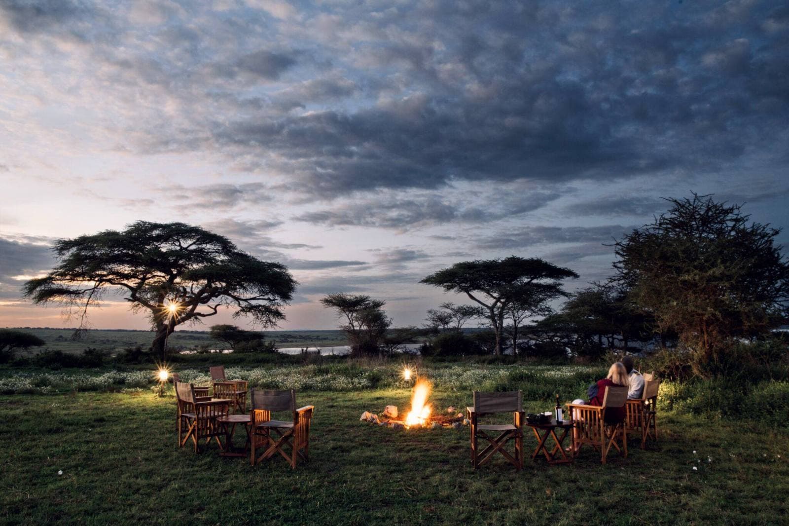Luxury tented safari camp in remote Tanzanian wilderness at dusk