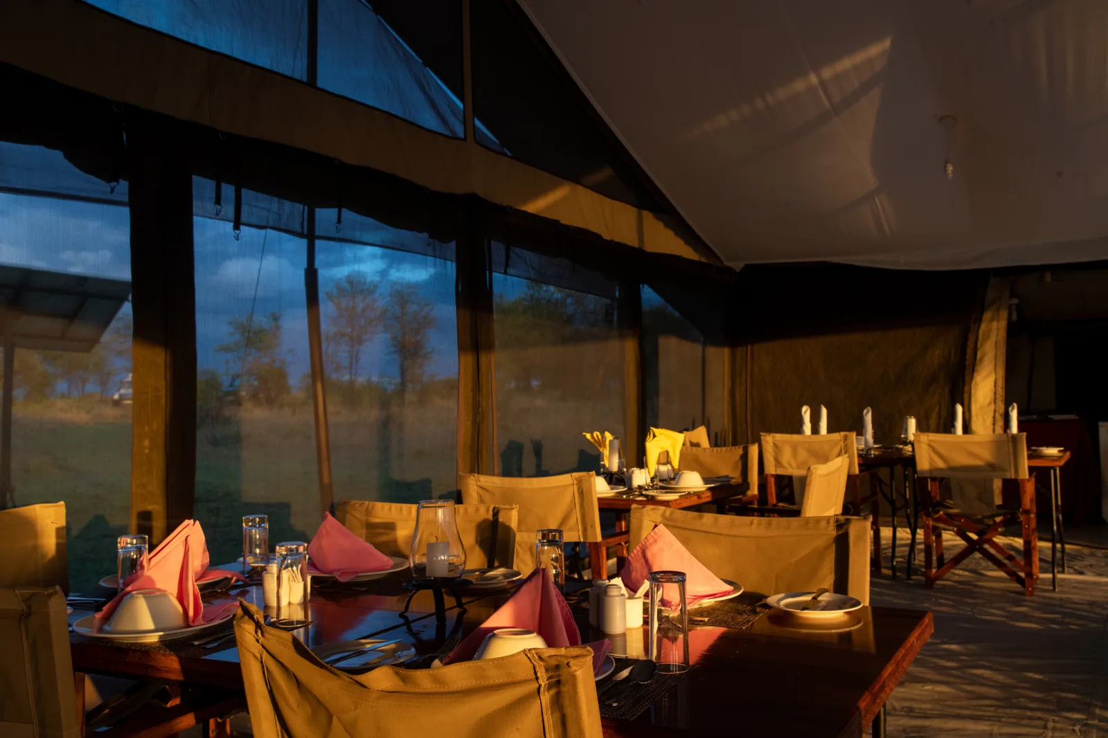 Dining tent with tables set for dinner