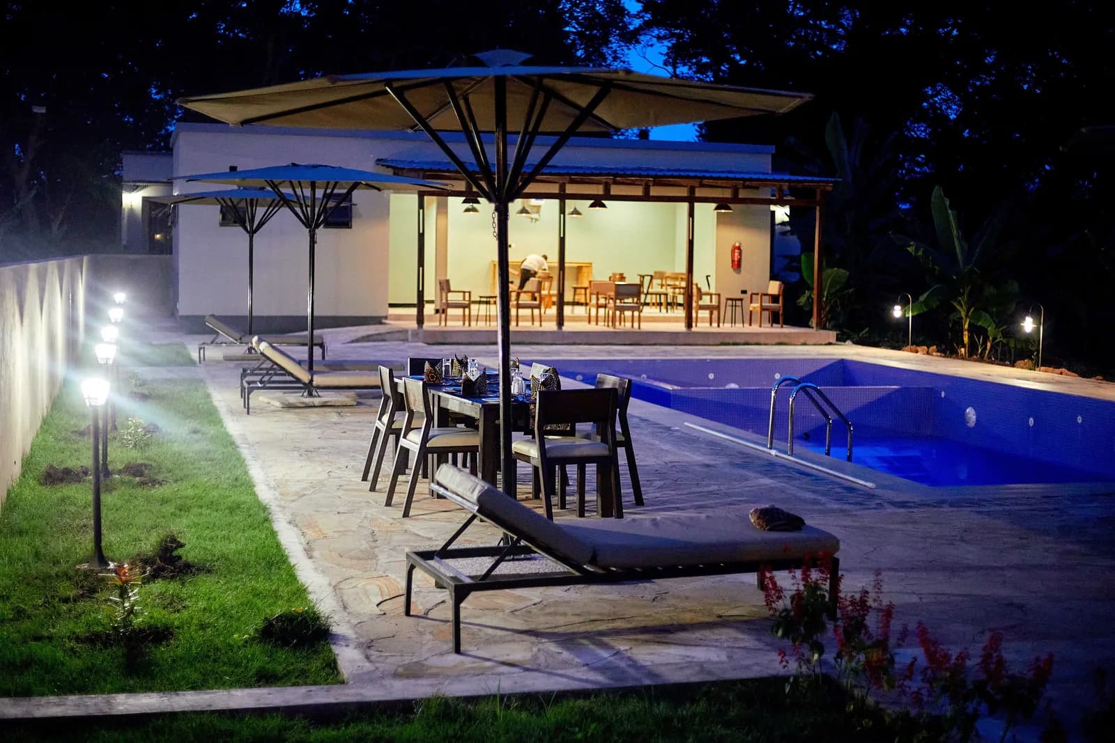 Pool and terrace tables lit up at night